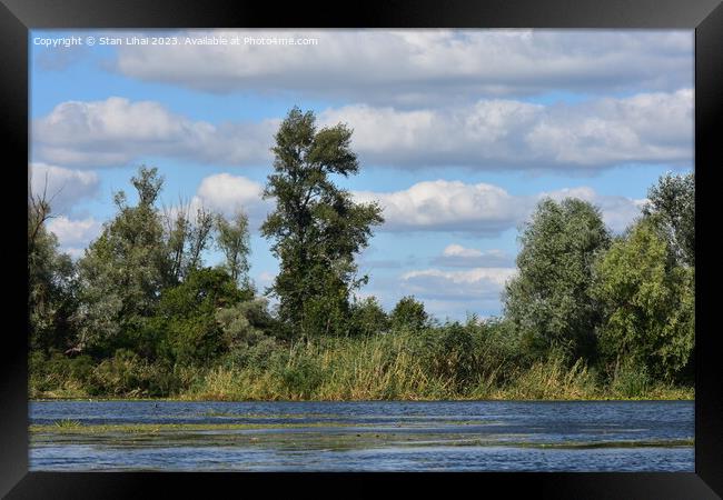 Cumulus clouds over the forest on Dnipro river Framed Print by Stan Lihai