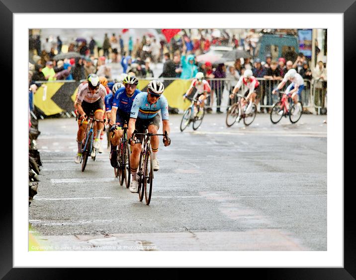 Men's cycling road race Framed Mounted Print by John Rae