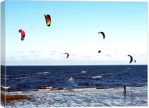 Harnessing Coastal Breezes: Kite Surfers at Norfol Canvas Print by john hill