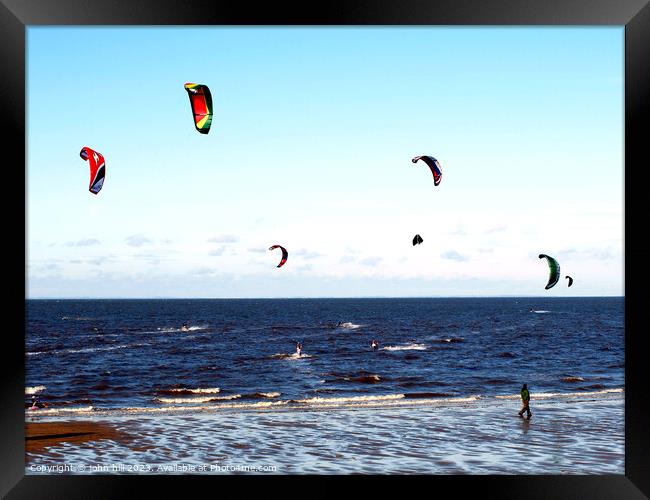 Harnessing Coastal Breezes: Kite Surfers at Norfol Framed Print by john hill