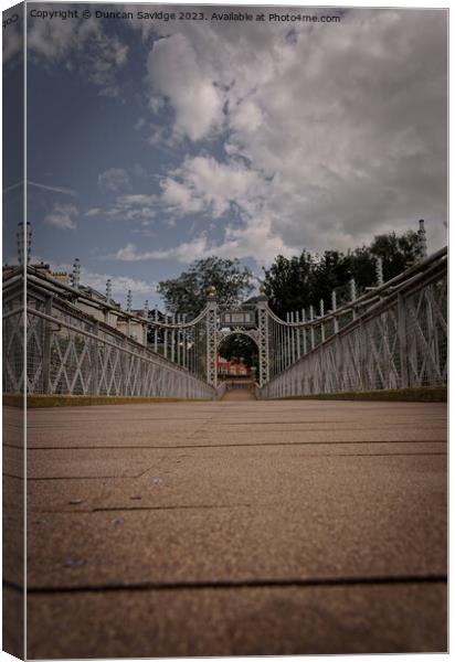 The Queens Park Suspension Bridge is a footbridge crossing the river Dee in Chester at the Groves. Canvas Print by Duncan Savidge