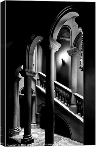 Illuminated Stairwell Arches at Penrhyn Castle Canvas Print by Mike Shields