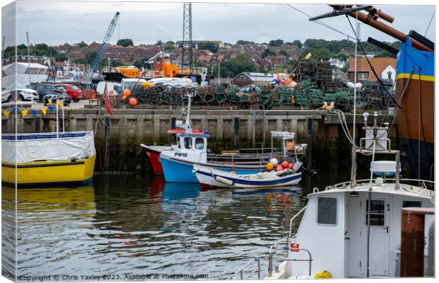 Fishing boats in Whitby harbour Canvas Print by Chris Yaxley