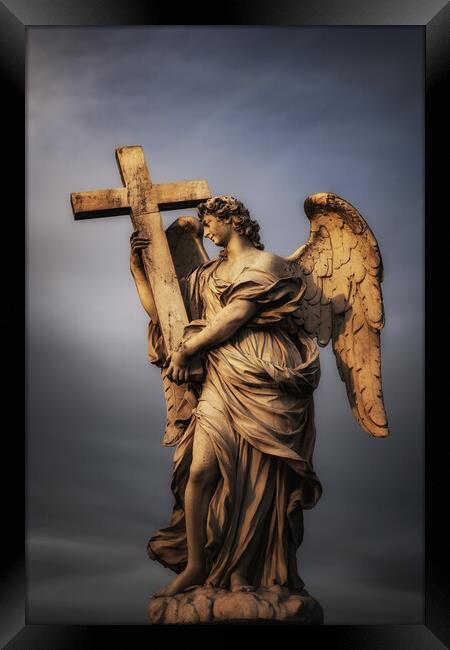 Angel Carrying The Cross Framed Print by Artur Bogacki