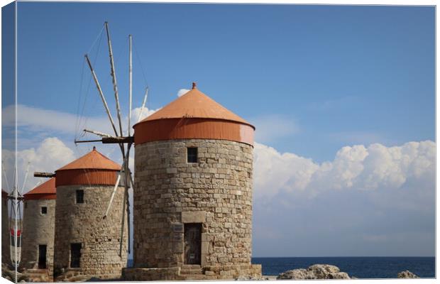 Windmills at the seafront in the city of Rhodes in Rhodes island in Greece Canvas Print by Virginija Vaidakaviciene