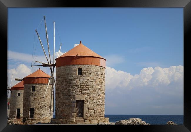Windmills at the seafront in the city of Rhodes in Rhodes island in Greece Framed Print by Virginija Vaidakaviciene