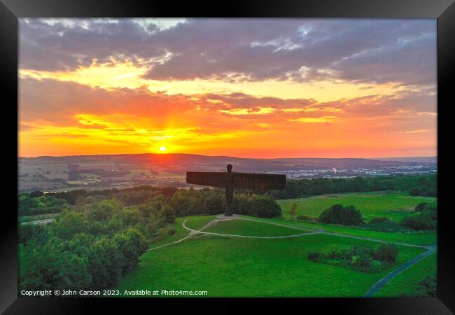 A sunset over the Angel of the north Framed Print by John Carson