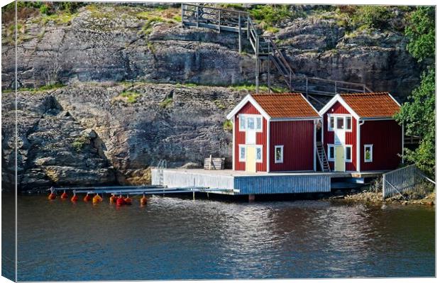 Boathouses on Orust Island in Western Sweden Canvas Print by Martyn Arnold
