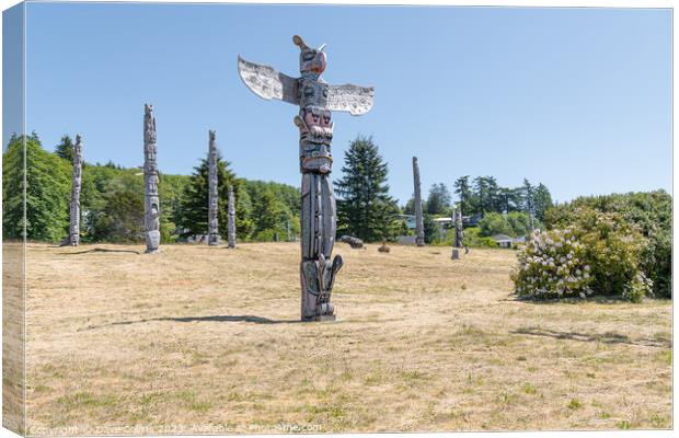 Ceremonial Totem Poles in the Namgis Burial Grounds in Alert Bay, British Columbia, Canada Canvas Print by Dave Collins