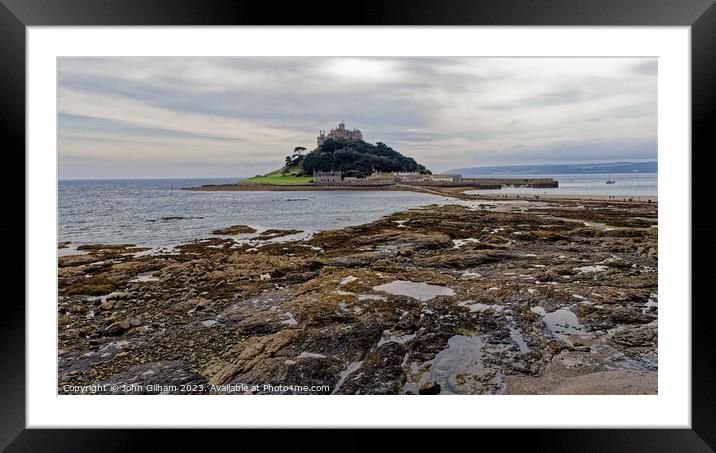 St Michaels Mount Marazion Cornwall England UK seen from a rocky outcrop on the mainland beach Framed Mounted Print by John Gilham