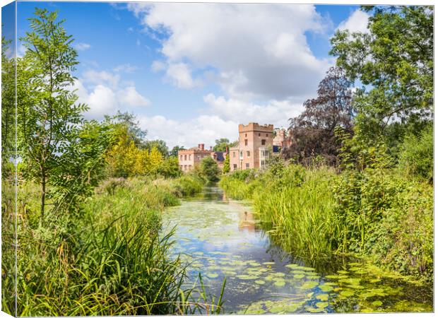 Oxborough Hall over a channel of water Canvas Print by Jason Wells