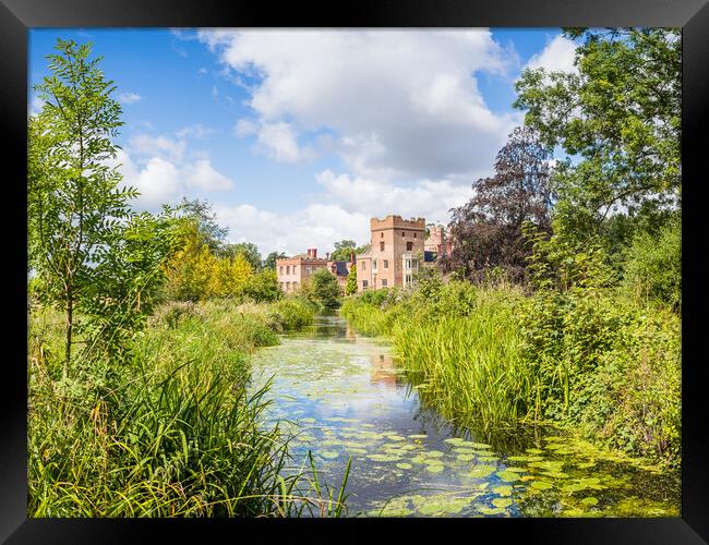Oxborough Hall over a channel of water Framed Print by Jason Wells