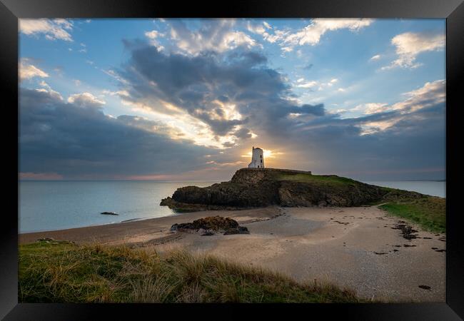 Sun setting behind Twr Mawr Lighthouse, Wales Framed Print by Andrew Kearton