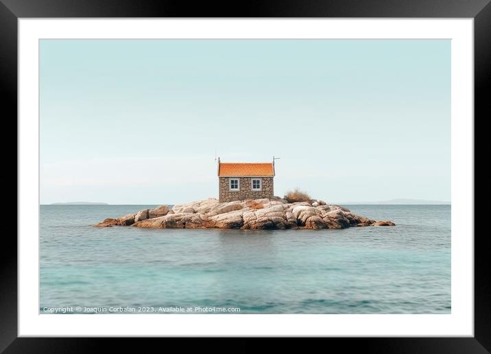 The rise in sea level leaves a small house on a promontory isolated. Framed Mounted Print by Joaquin Corbalan