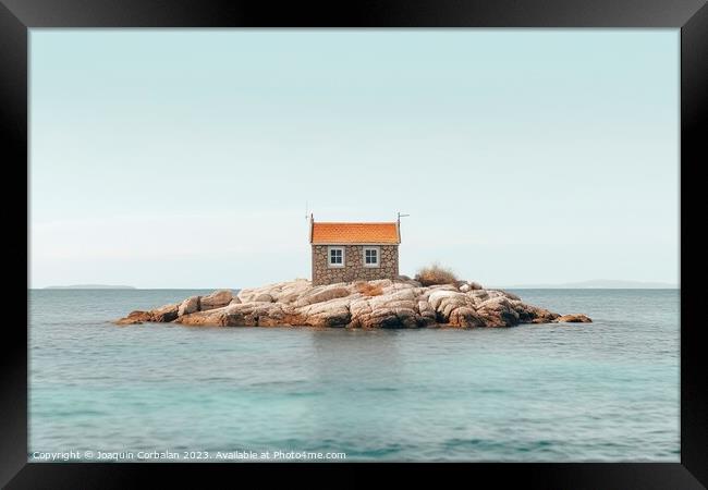 The rise in sea level leaves a small house on a promontory isolated. Framed Print by Joaquin Corbalan