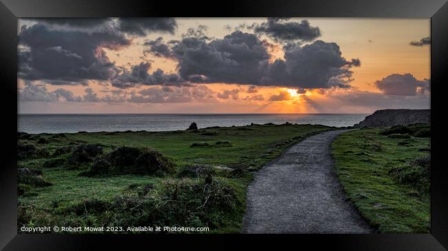 The sun setting at Kynance Cove, Cornwall Framed Print by Robert Mowat
