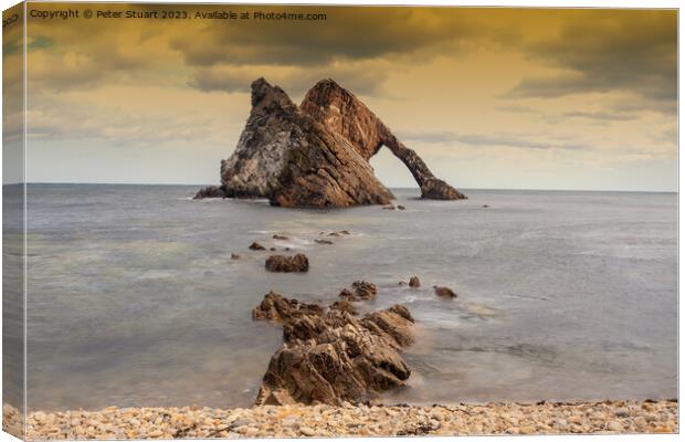 Bow Fiddle Rock is a natural sea arch near Portknockie on the no Canvas Print by Peter Stuart