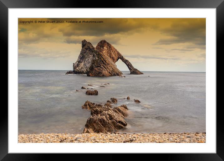 Bow Fiddle Rock is a natural sea arch near Portknockie on the no Framed Mounted Print by Peter Stuart