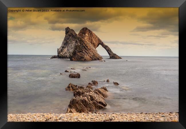 Bow Fiddle Rock is a natural sea arch near Portknockie on the no Framed Print by Peter Stuart