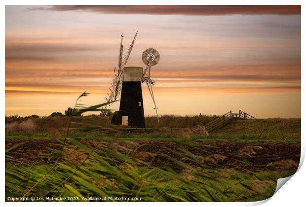 Windmill through the tall grass Print by Les McLuckie