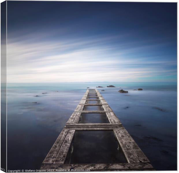 Wooden pier remains in a blue sea. Long Exposure. Canvas Print by Stefano Orazzini