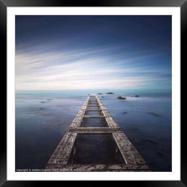 Wooden pier remains in a blue sea. Long Exposure. Framed Mounted Print by Stefano Orazzini