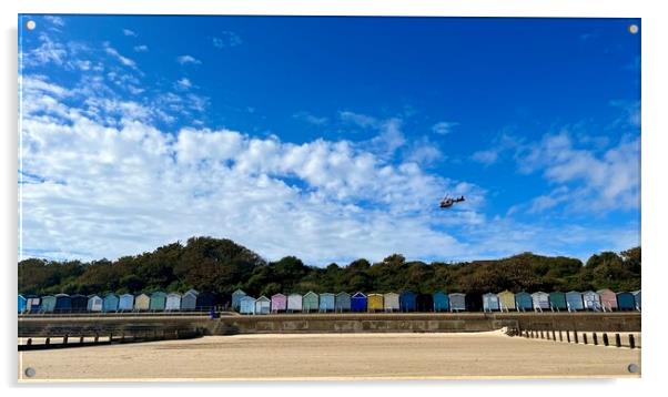 Air ambulance taking off over beach huts at Frinton  Acrylic by Paula Tracy