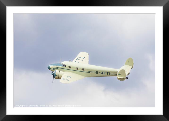 Lockheed Electra in a cloudy sky Framed Mounted Print by Steve de Roeck