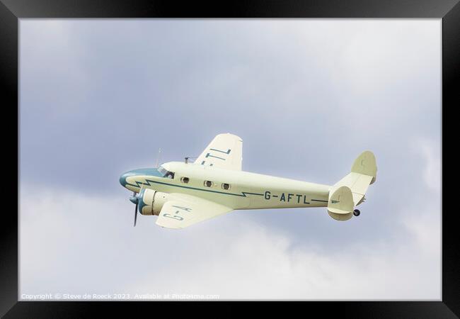 Lockheed Electra in a cloudy sky Framed Print by Steve de Roeck