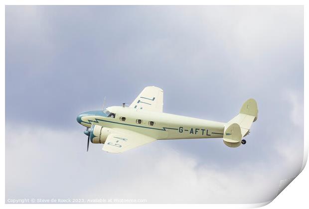Lockheed Electra in a cloudy sky Print by Steve de Roeck