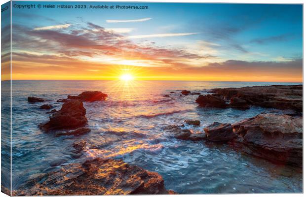 Stunning sunrise over the beach at Torre de la Sal Canvas Print by Helen Hotson