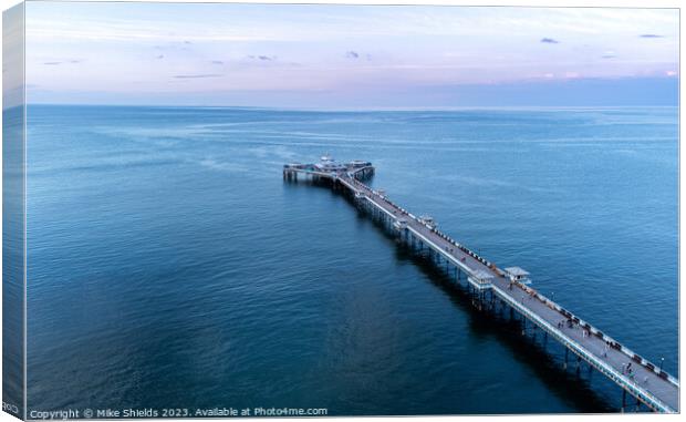 Pier in calm waters Canvas Print by Mike Shields
