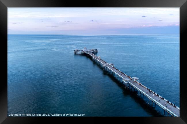 Pier in calm waters Framed Print by Mike Shields