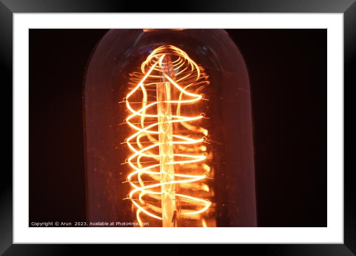 Vintage bulb glowing Framed Mounted Print by Arun 