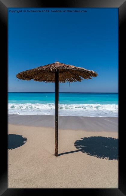 A straw topped Beach Umbrella on Lefkada Framed Print by Jo Sowden