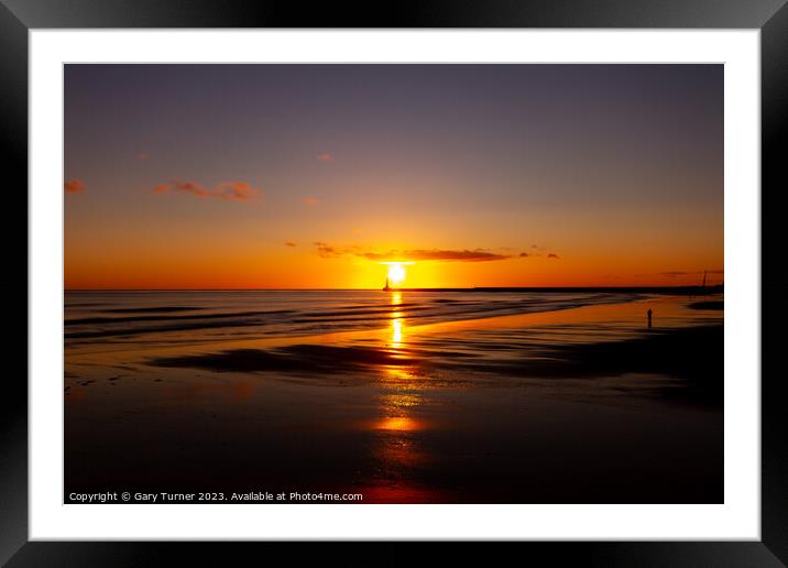 Lone walker catches the sunrise at Roker Pier, Sunderland Framed Mounted Print by Gary Turner