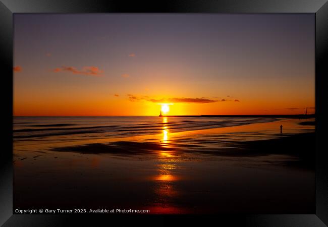 Lone walker catches the sunrise at Roker Pier, Sunderland Framed Print by Gary Turner