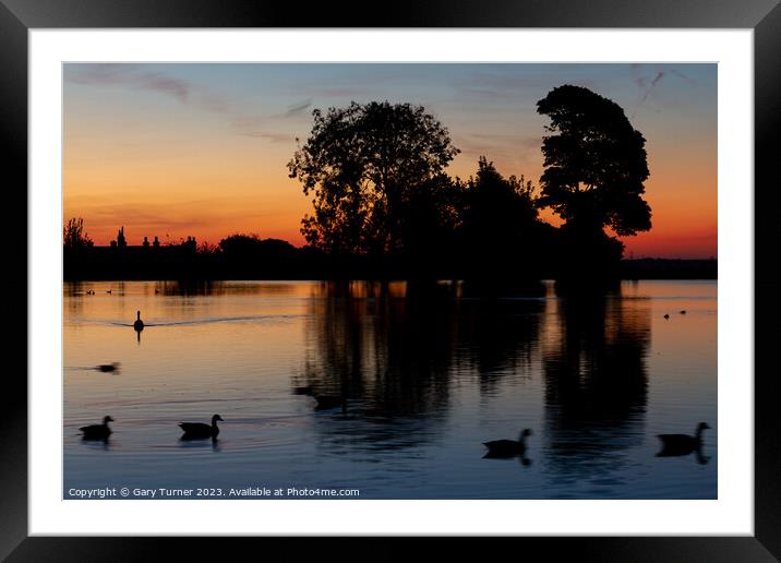Sunrise reflected in the lake Framed Mounted Print by Gary Turner