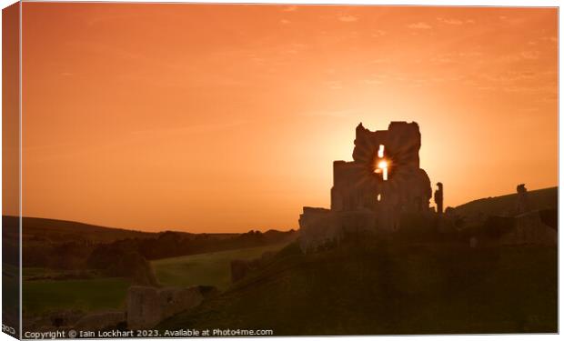 Corfe Castle silhouetted against the sunset Canvas Print by Iain Lockhart
