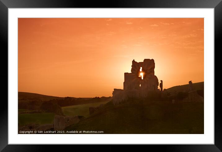 Corfe Castle silhouetted against the sunset Framed Mounted Print by Iain Lockhart