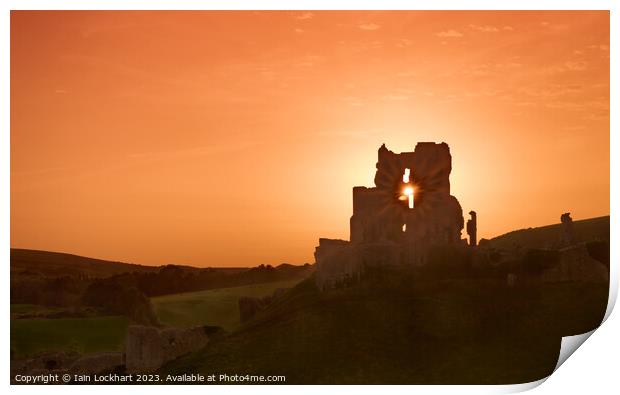 Corfe Castle silhouetted against the sunset Print by Iain Lockhart