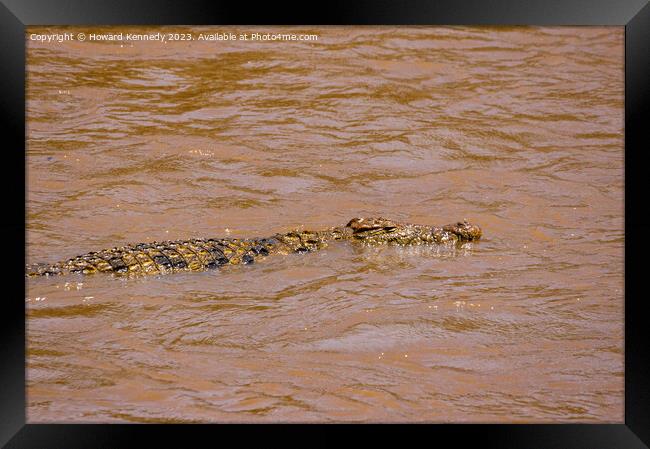 Nile Crocodile swimming in the Mara River Framed Print by Howard Kennedy