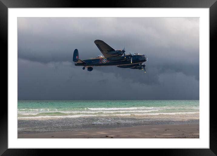 Lancaster bomber over the sea and under a dark, cloudy sky Framed Mounted Print by Kevin Hellon