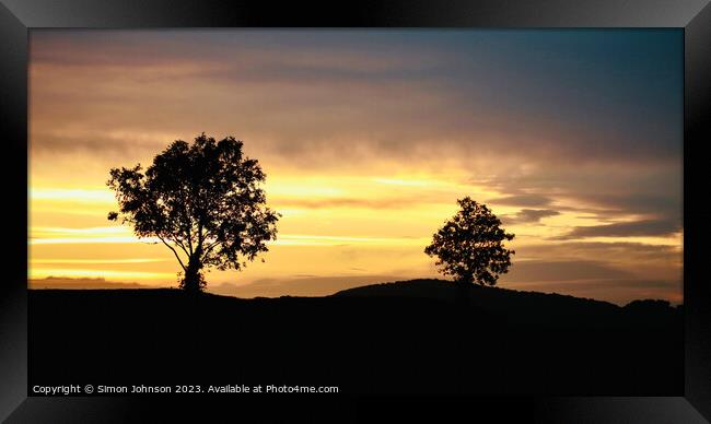 A tree with a sunset in the background Framed Print by Simon Johnson