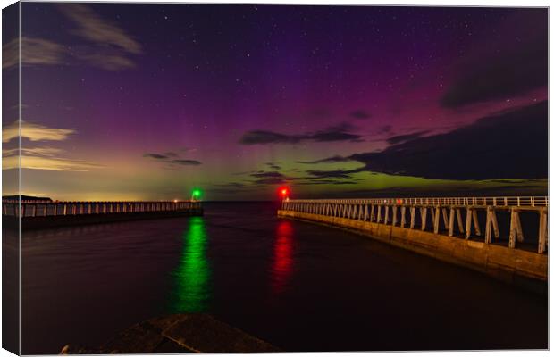 Northern Lights over the piers in Whitby Canvas Print by Kevin Winter