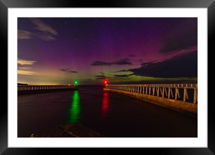 Northern Lights over the piers in Whitby Framed Mounted Print by Kevin Winter