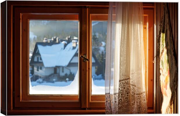 Beautiful view from window on winter village with  Canvas Print by Olga Peddi