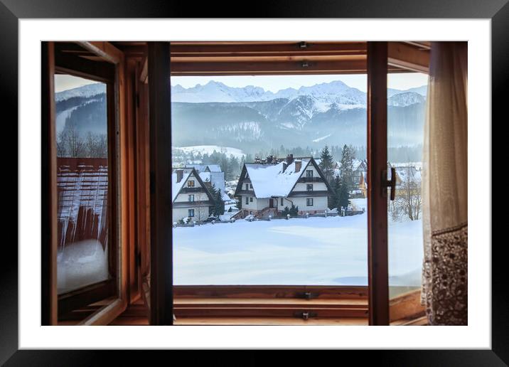 Beautiful view from an open window to a winter vil Framed Mounted Print by Olga Peddi
