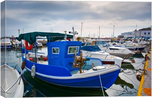 Greek fishing boats stays parked near sea pier at Vlychada town  Canvas Print by Olga Peddi