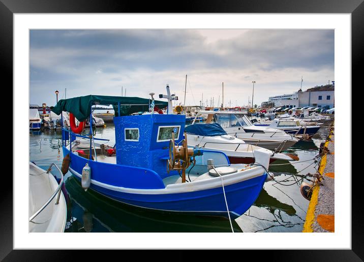 Greek fishing boats stays parked near sea pier at Vlychada town  Framed Mounted Print by Olga Peddi